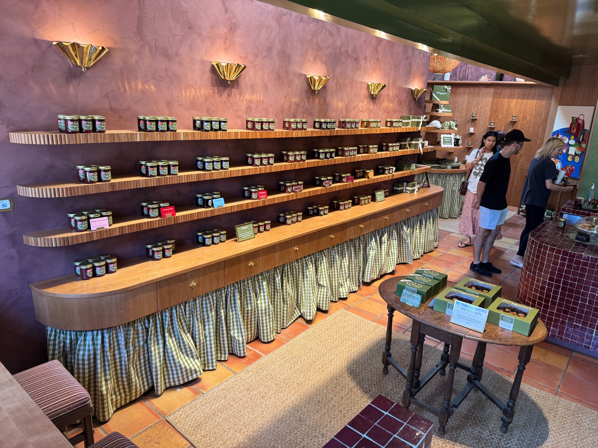 Completed Jamagansett retail interior with custom cherry shelving, cabinetry, and integrated display millwork
