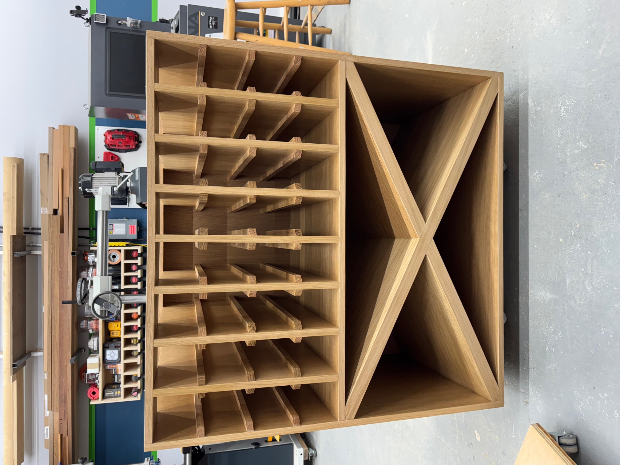 Custom white oak bottle storage cabinet during fabrication in the Maidstone shop
