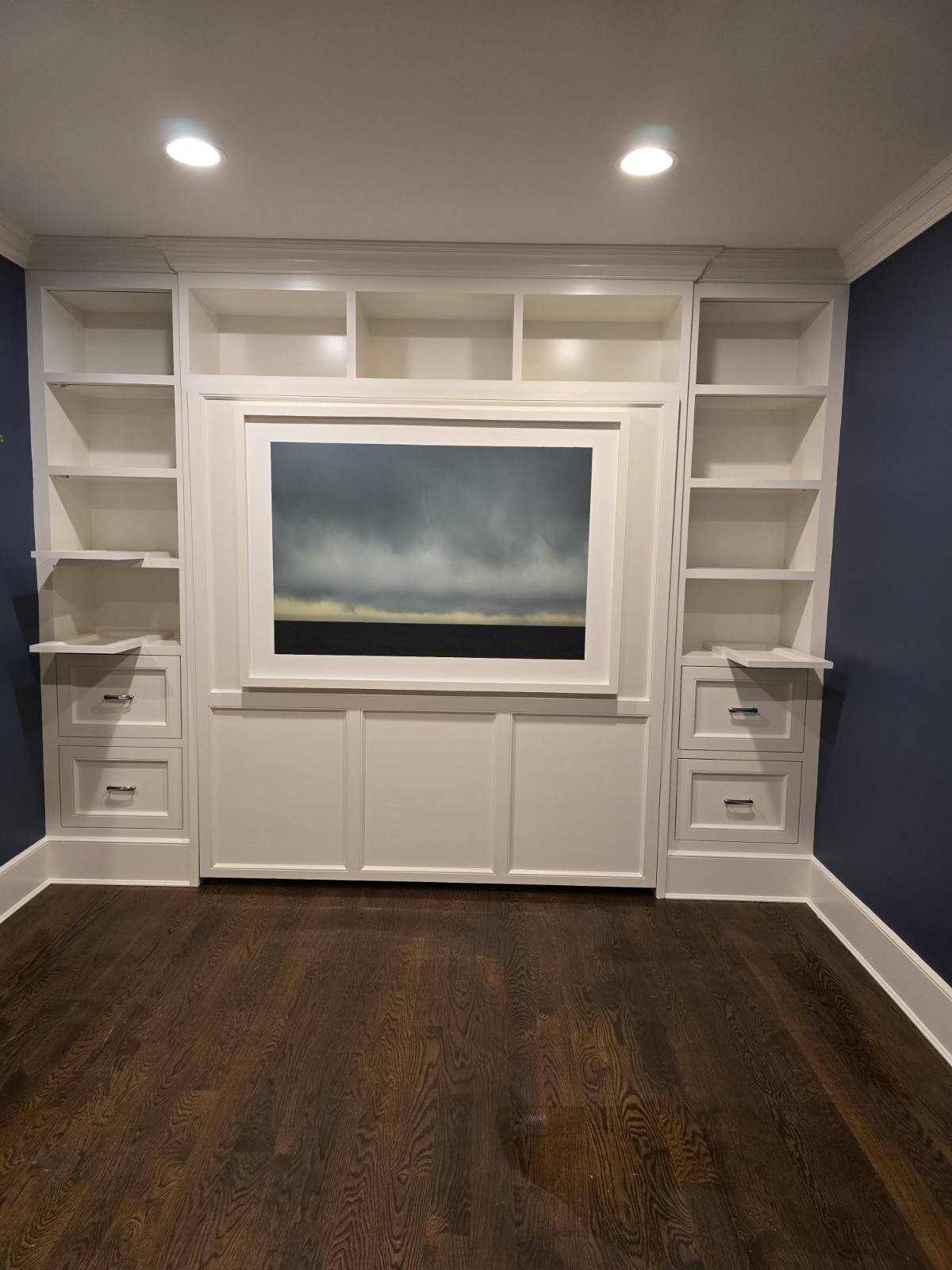 Finished painted Murphy bed wall with flanking bookshelves and fitted drawers